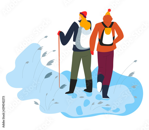 Hikers walking on snow with trekking pole and backpacks