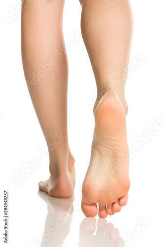 Female feet in nylon hosiery on white background © vladimirfloyd