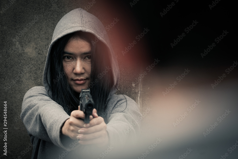 The young woman holds the money and the gun. crime, stray, dark side, drugs, selected focus, vintage style The young woman holds the money and the gun. crime, stray, dark side, drugs, selected focus, vintage style