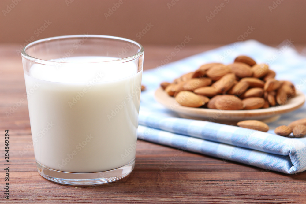 Almond milk and almonds on the table. Vegetable milk. Vegetarian milk. Almond milk and almonds on the table. Vegetable milk. Vegetarian milk.