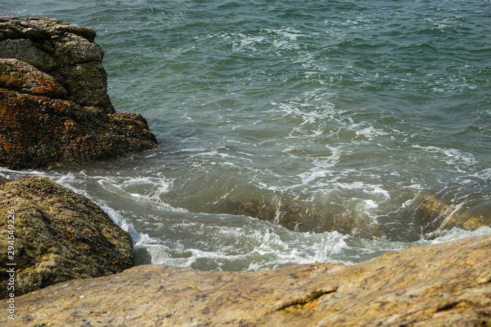 Waves breaking on the shore with sea foam Waves breaking on the shore with sea foam