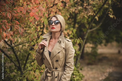 Woman at autumn in fashionable beige coat, vogue and clothes concept