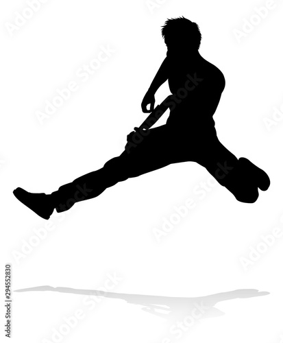 A guitarist musician in detailed silhouette playing his guitar musical instrument.