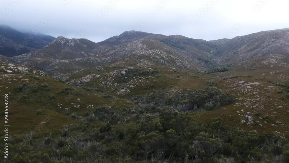 Aerial: Flying over remote mountain terrain in Tasmania Aerial: Flying over remote mountain terrain in Tasmania