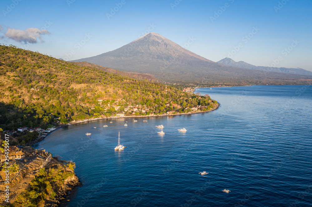 Sunrise over the Jemeluk bay in the Amed area with the famous Agung volcano in northeast Bali in Indonesia Sunrise over the Jemeluk bay in the Amed area with the famous Agung volcano in northeast Bali in Indonesia
