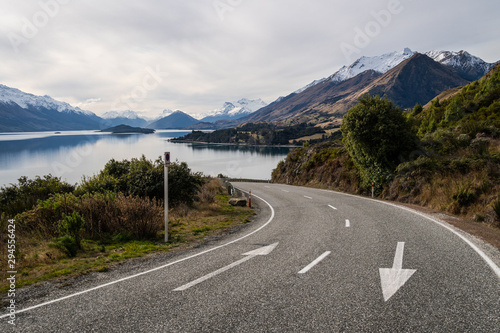 Winding road along the stunning lake Wakapitu between Queenstown and Glenorchy in New Zealand south island.