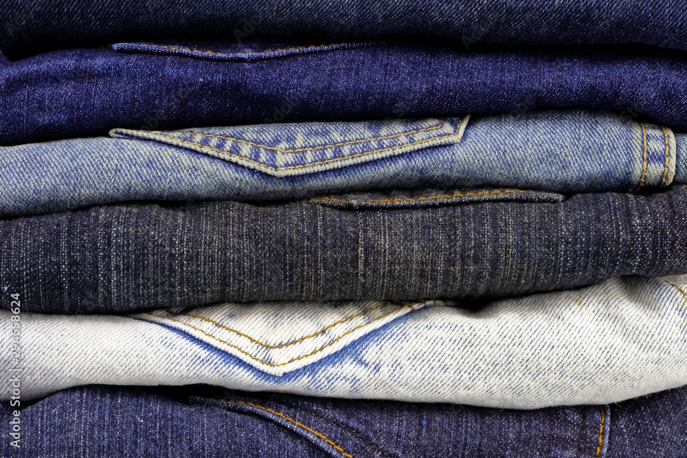 Close up various type and color of denim fabrics, Jeans trousers folded and stacked.