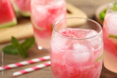 Delicious refreshing watermelon drink on wooden table, closeup