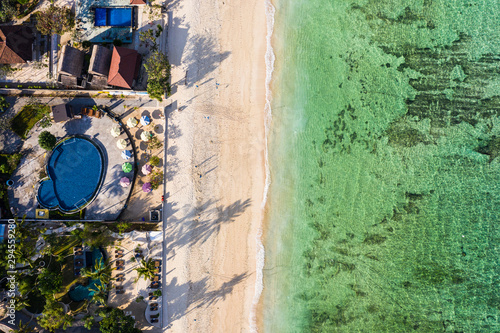 Top down view of Nusa Lembongan beach lined with resort and hotel in Bali, Indonesia