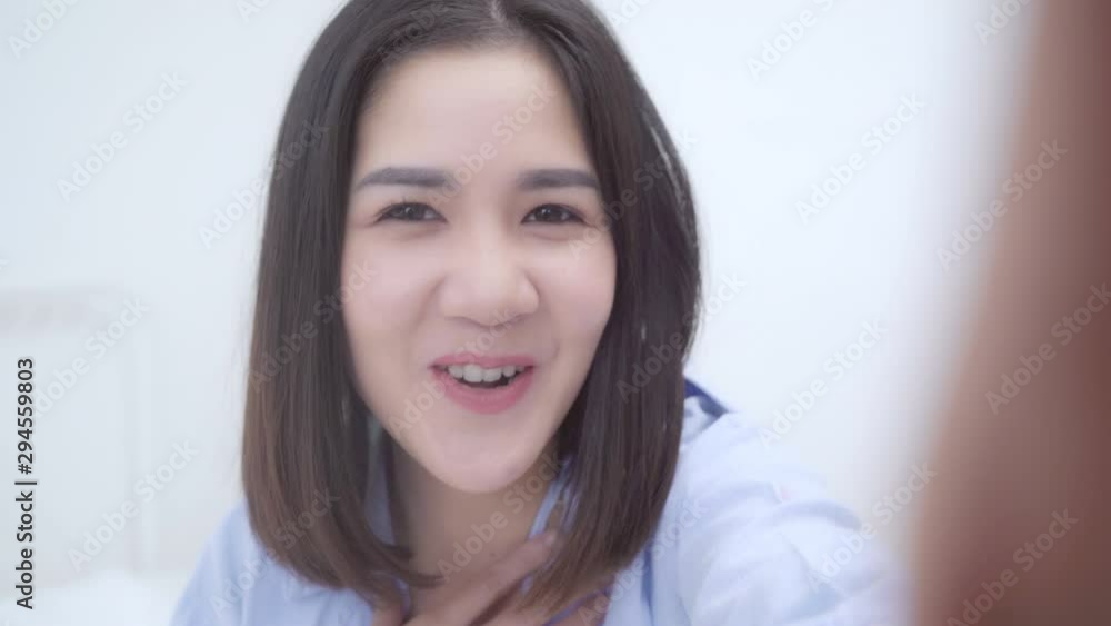 Young Asian teenager woman vlog at home, Japanese female using smartphone making vlog video to social media on bed in bedroom. Lifestyle woman relax in morning at home concept. Looking at camera. Young Asian teenager woman vlog at home, Japanese female using smartphone making vlog video to social media on bed in bedroom. Lifestyle woman relax in morning at home concept. Looking at camera.