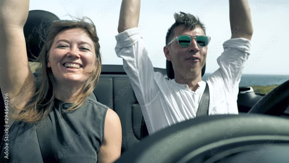 car travel couple having fun on summer road trip vacation driving to holidays ina cabriolet car travel couple having fun on summer road trip vacation driving to holidays ina cabriolet