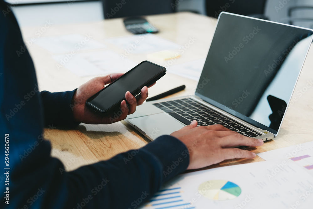 Business man analyzing investment graph and discussing plan in meeting room with laptop, investment concept Business man analyzing investment graph and discussing plan in meeting room with laptop, investment concept