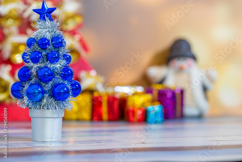 Merry Christmas New Year collection, gifts and decorative ornaments. Holiday Season background with decorations. Blue, green xmas trees. Gift boxes various colours. Copy space for text.