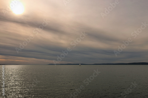 Stunning autumn landscape of lake Balaton. Vibrant sky in cloudy day. Sun reflected in water.  Balatonfoldvar  Hungary