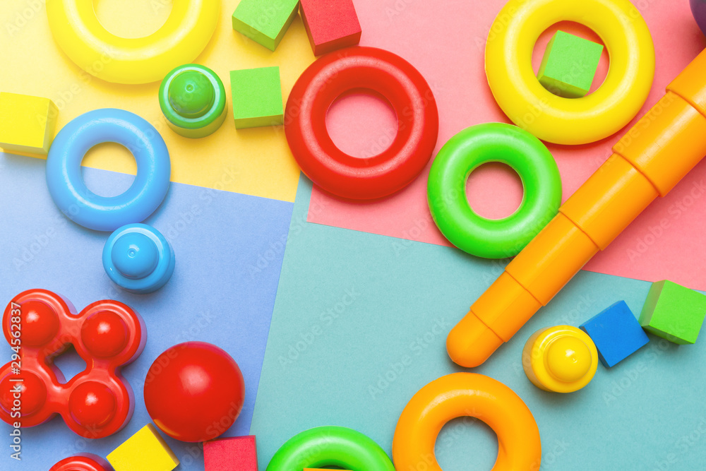 Fototapeta premium Colorful child kid’s education toys pattern background copy space mockup on the bright color background. Childhood education infancy children baby concept. Flat lay, top view, close up