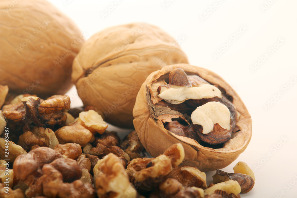 A pile of peeled walnuts at white background A pile of peeled walnuts at white background