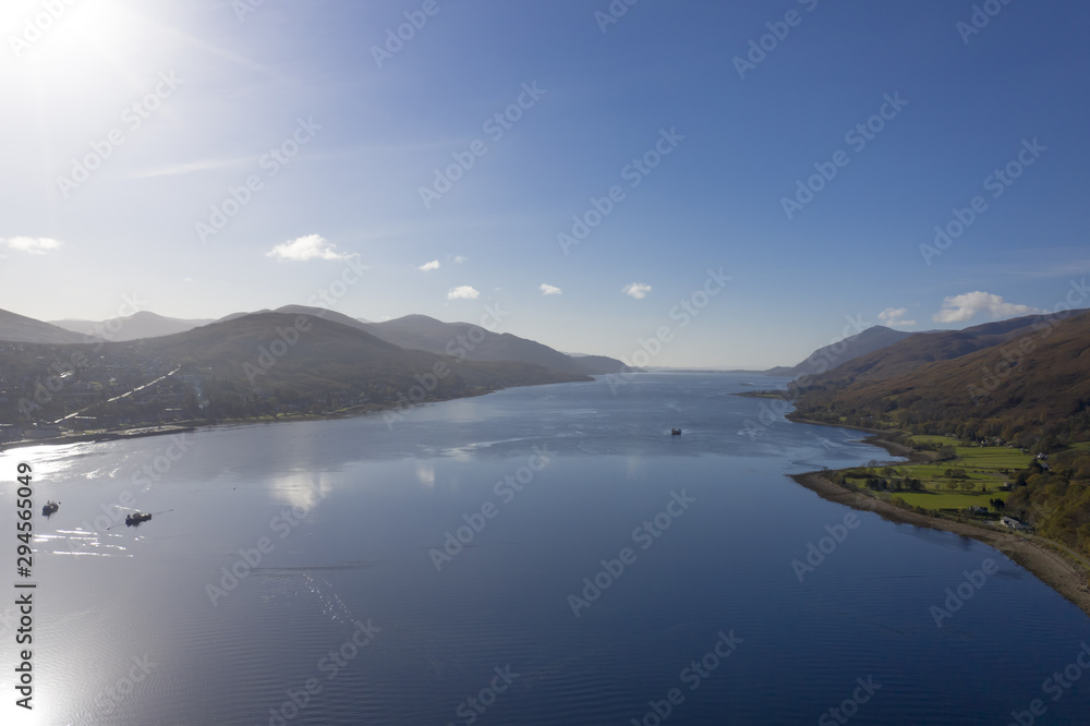Scottish Loch aerial view in the UK with boats and bright sunshine Scottish Loch aerial view in the UK with boats and bright sunshine