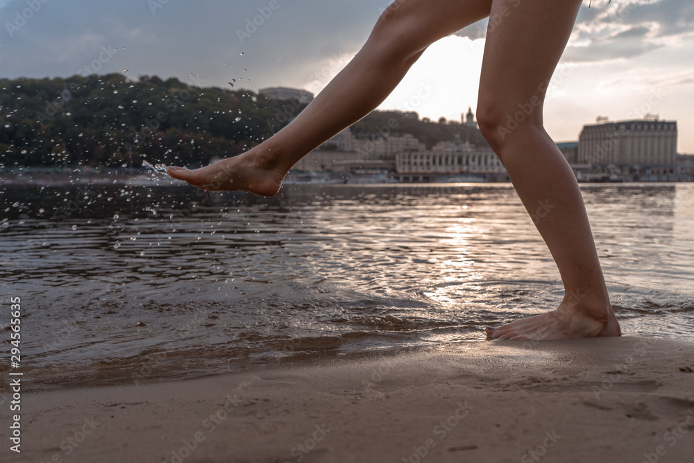 Woman walking on the beach and playing with the water Woman walking on the beach and playing with the water