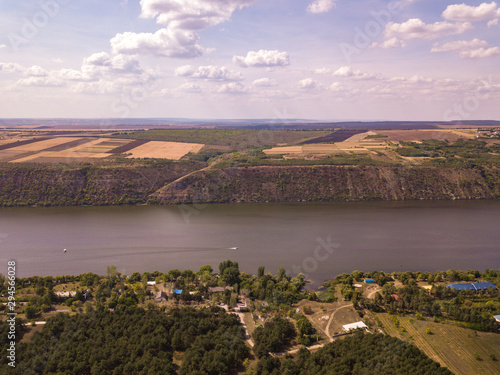 Arial view over the river and small village in autumn. Moldova republic of. Molovata village. River Dniester.