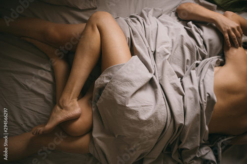 Canvas Print cuddling hugging couple in bed. intimate time in bed