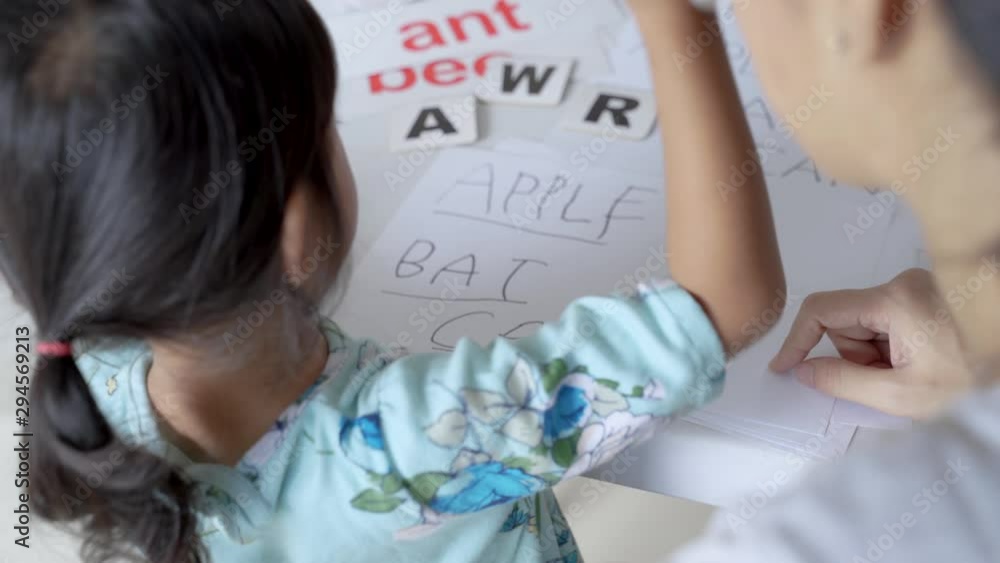 happy mother teaching her daughter the basic to read and write at home. toddler kindergarten student happy mother teaching her daughter the basic to read and write at home. toddler kindergarten student