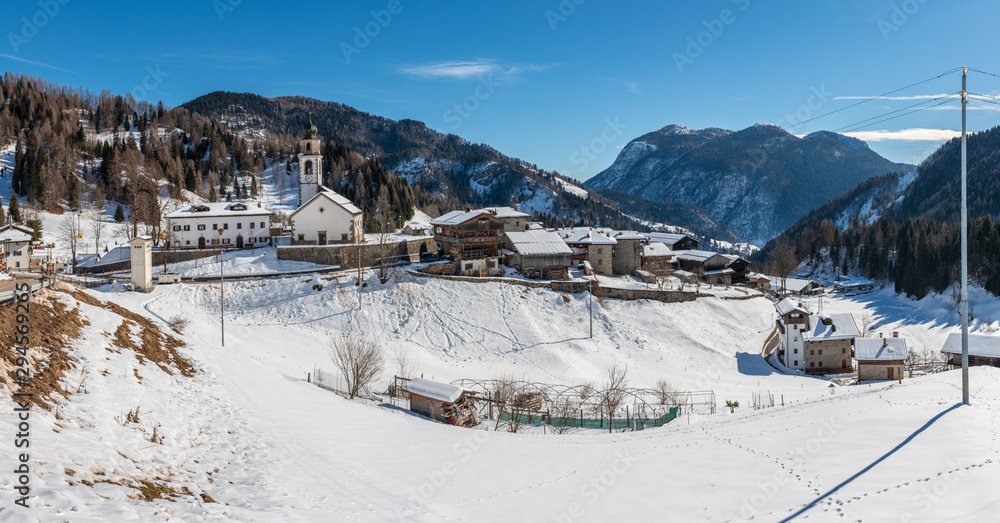 Winter in Sauris di Sotto. Magic of snow and old wooden houses. Italy