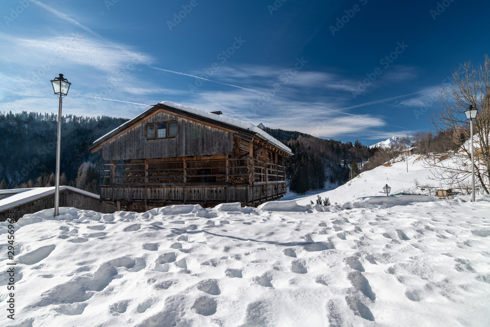 Winter in Sauris di Sotto. Magic of snow and old wooden houses. Italy