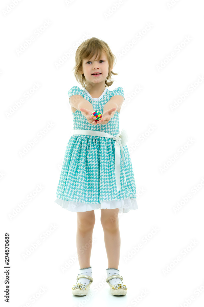 Little girl holding a ball on outstretched hands Little girl holding a ball on outstretched hands