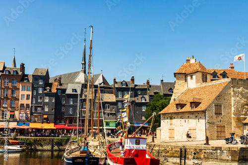 Honfleur harbor in Normandy, restaurant street with marina view in Honfleur, France, 2019 photo