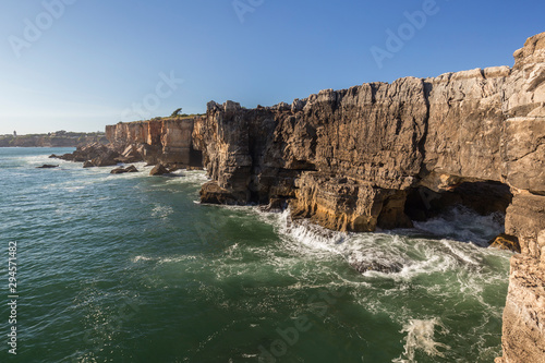 Scenic view of the Boca do Inferno (Hell's Mouth) in Cascais, Portugal, on a sunny day. It's a chasm in the seaside cliff and popular tourist attraction.