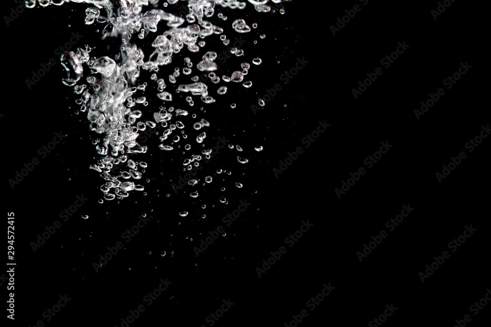 water splash with bubbles of air, isolated on a black background.