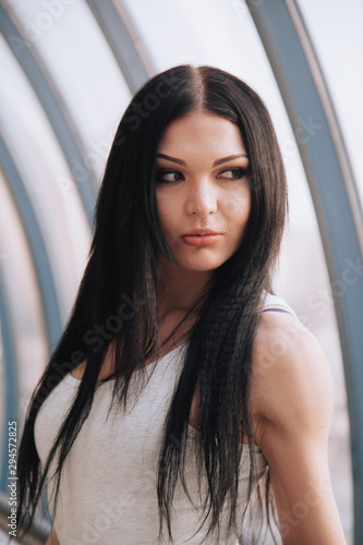 attractive fitness woman lifestyle portrait. caucasian model walking in the city © goldeneden