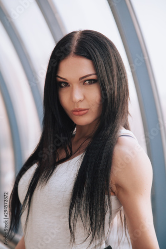 Free Download attractive fitness woman lifestyle portrait. caucasian model walking in the city - GFXLoad