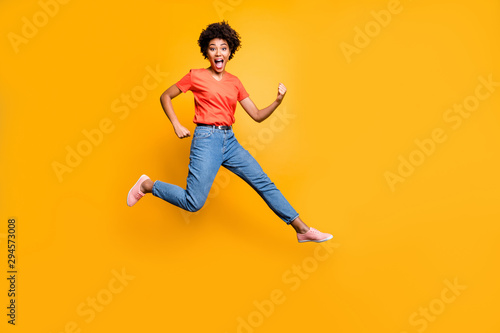 Fototapeta Naklejka Na Ścianę i Meble -  Full length photo of crazy funky funny girl scream have fun jump wear casual trendy lifestyle outfit sneakers isolated over yellow bright color background