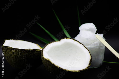 Geöffnete Kokosnuss mit Kokosöl im Glas 