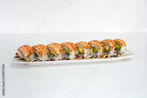 Shrimp smoked filled avocado, kani, tamago, cucumber pickle sushi roll with teriyaki sauce
