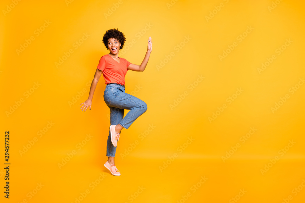 Copyspace photo of cheerful charming fascinating gorgeous nice cute girlfriend running away from something changing position isolated over vivid color yellow background
