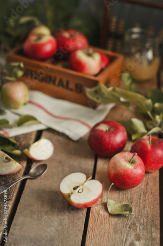 Harvest of red apples on wooden background