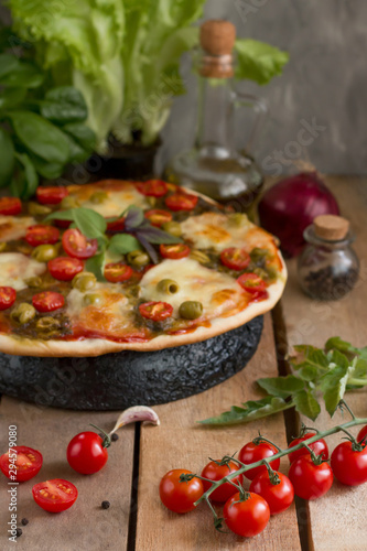 Hot pizza with tomatoes, mozzarella and basil