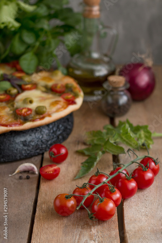 Hot pizza with tomatoes, mozzarella and basil