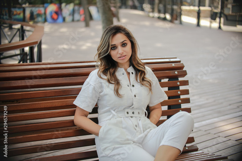 beautiful woman with wavy dark hair walks around the city