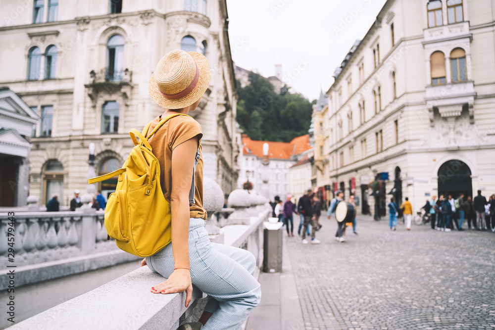Young girl with backpack in  Ljubljana Old Town. Travel Slovenia - obrazy, fototapety, plakaty 