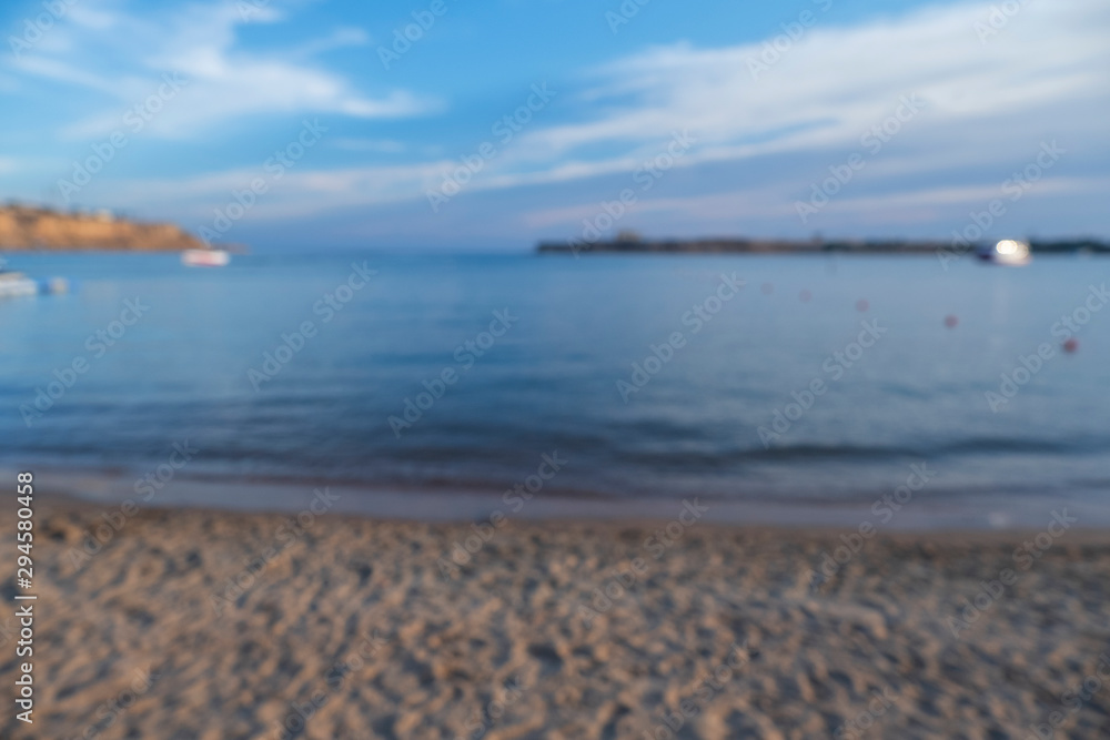 Blurred bokeh background texture of a beach, tropical seashore. Sunset view