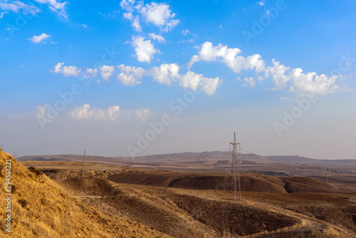 High voltage power poles in hilly terrain