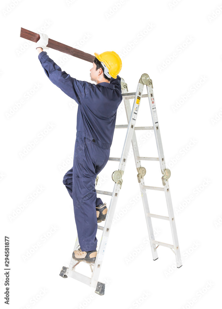 Handyman in uniform standing on ladder holding wood plank on white Handyman in uniform standing on ladder holding wood plank on white