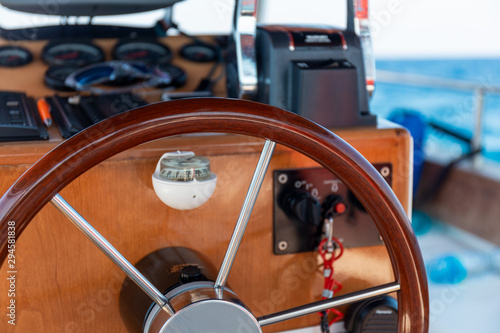 A boat wooden helm and compass © Andrey Tarakanov