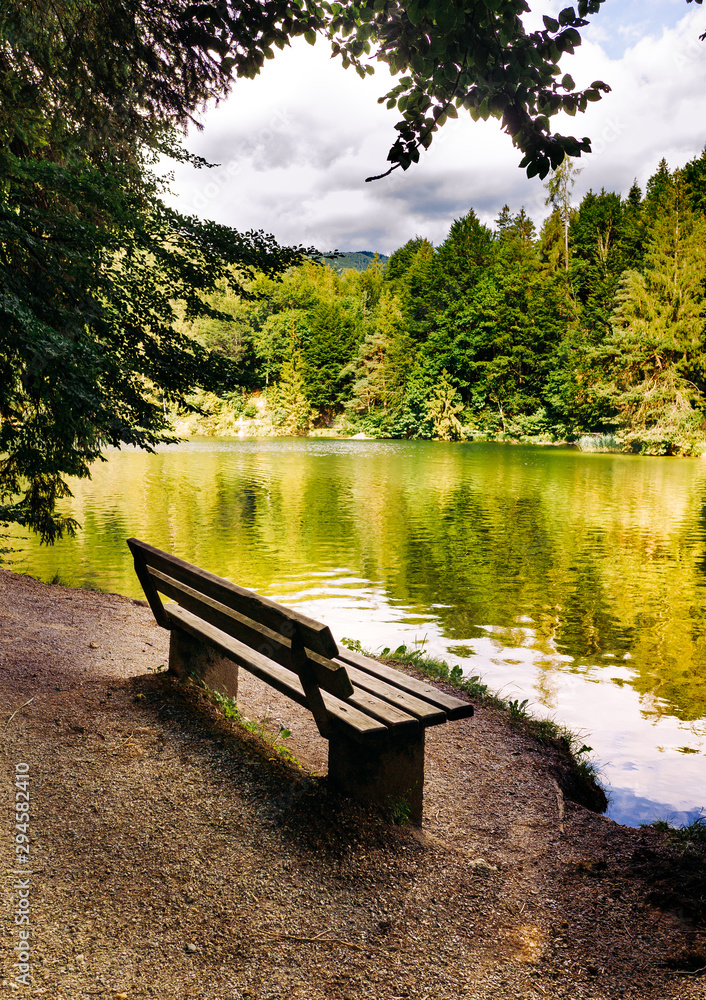 Bench near the picturesque mountain lake Bench near the picturesque mountain lake