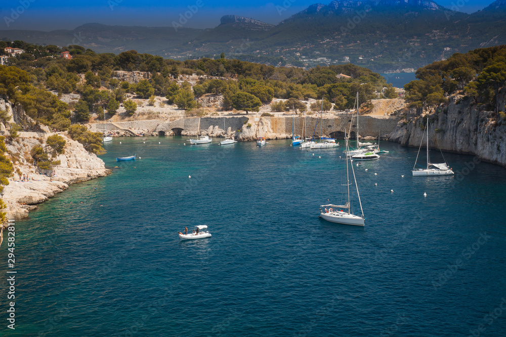 Sailboats moored in a bay of the rocky coast, Calanque de Port Pin, Provence, France, Europe Sailboats moored in a bay of the rocky coast, Calanque de Port Pin, Provence, France, Europe