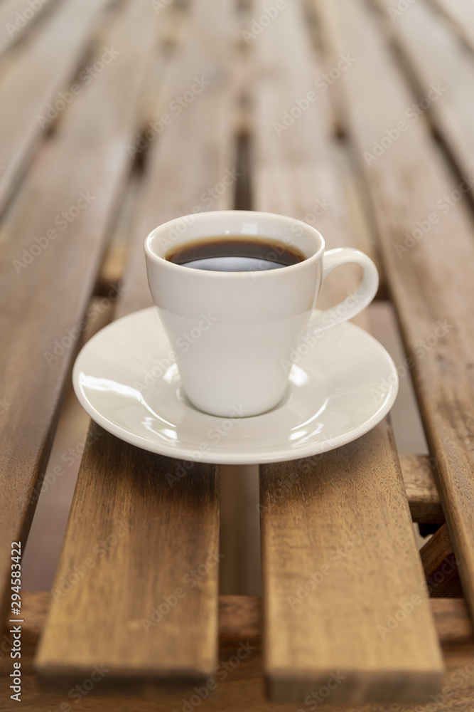 Minimalistic coffee cup on wooden table