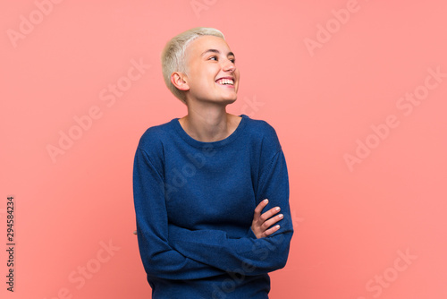 Teenager girl with white short hair over pink wall happy and smiling photo